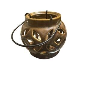 Brown ceramic candle lantern or luminary with a metal handle